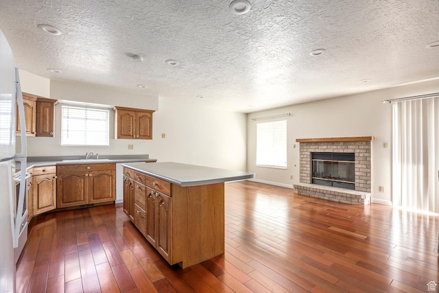 176 N 170 E, Orem, UT 84057 - kitchen with a sink, a textured ceiling, a kitchen island, and a wealth of natural light