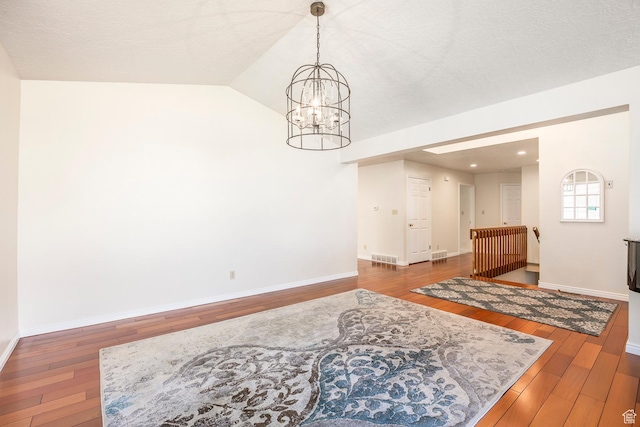 176 N 170 E, Orem, UT 84057 - dining space with wood-type flooring, visible vents, lofted ceiling, baseboards, and a notable chandelier