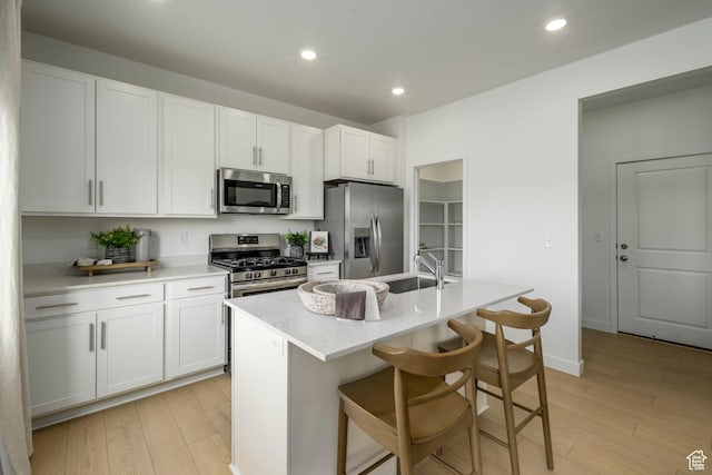 141 N Gallery St, Saratoga Springs, UT 84045 - kitchen with recessed lighting, a sink, light wood finished floors, and stainless steel appliances