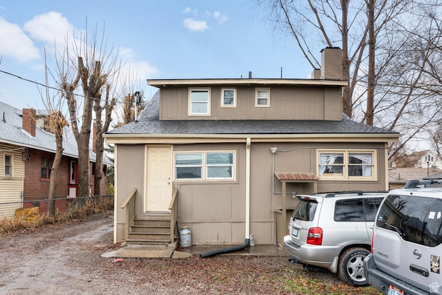1470 S Edison St, Salt Lake City, UT 84115 - view of front facade featuring roof with shingles, fence, a chimney, and entry steps