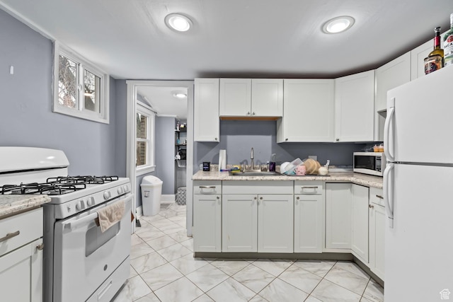 1470 S Edison St, Salt Lake City, UT 84115 - kitchen with light stone counters, a sink, white appliances, white cabinetry, and recessed lighting