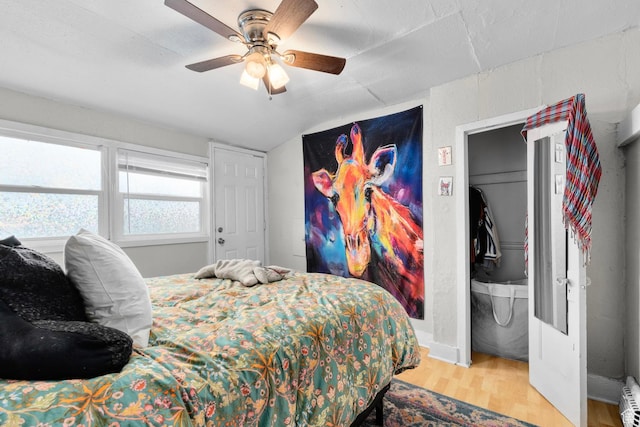1470 S Edison St, Salt Lake City, UT 84115 - bedroom with a baseboard radiator, a ceiling fan, wood finished floors, and vaulted ceiling