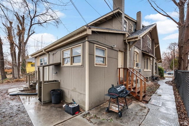 1470 S Edison St, Salt Lake City, UT 84115 - view of home's exterior featuring fence and a chimney