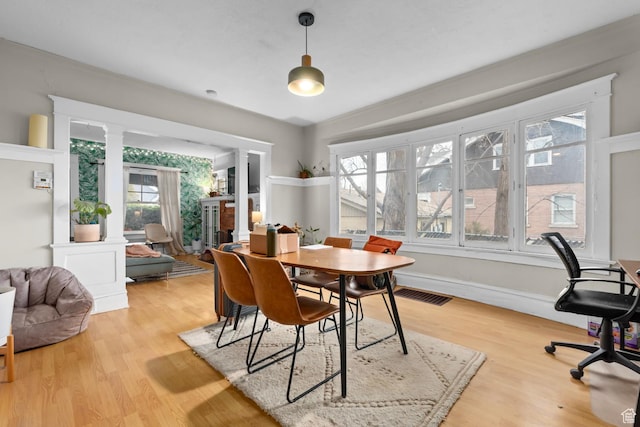 1470 S Edison St, Salt Lake City, UT 84115 - dining area with ornate columns, visible vents, a wealth of natural light, and light wood-style flooring