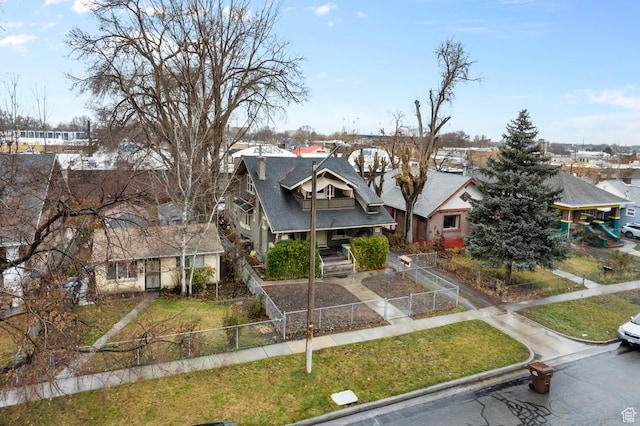 1470 S Edison St, Salt Lake City, UT 84115 - view of front facade featuring fence, a shingled roof, a front lawn, and a residential view