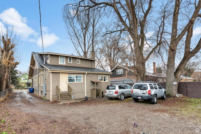 1470 S Edison St, Salt Lake City, UT 84115 - view of front of house with roof with shingles, fence, a chimney, and entry steps