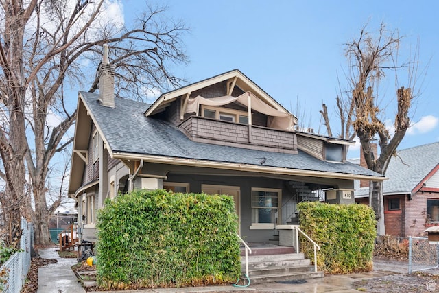 1470 S Edison St, Salt Lake City, UT 84115 - bungalow-style house featuring a porch, a chimney, roof with shingles, fence, and a balcony