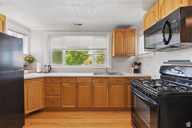 775 E Simpson Ave, Salt Lake City, UT 84106 - kitchen with a sink, a healthy amount of sunlight, black appliances, and visible vents