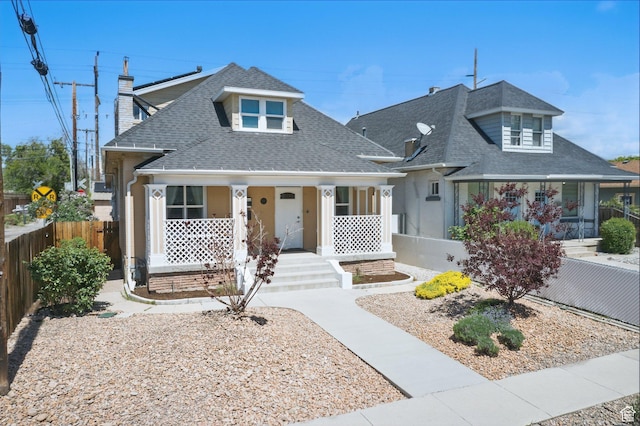 775 E Simpson Ave, Salt Lake City, UT 84106 - view of front of home featuring a porch, roof with shingles, fence, and a chimney