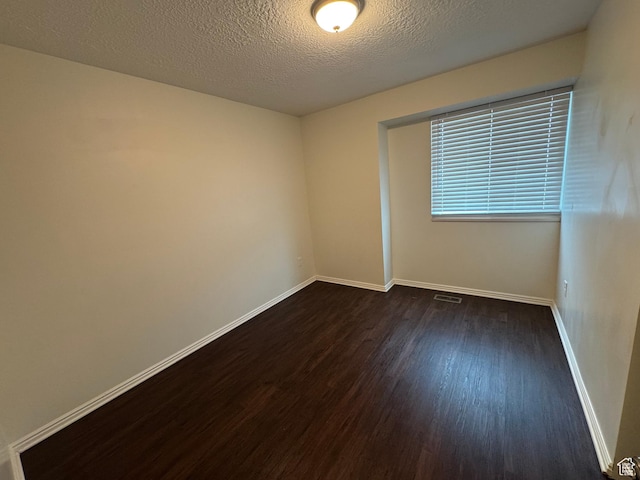 1952 E Sunset Dr, Layton, UT 84040 - empty room featuring baseboards, a textured ceiling, dark wood finished floors, and visible vents