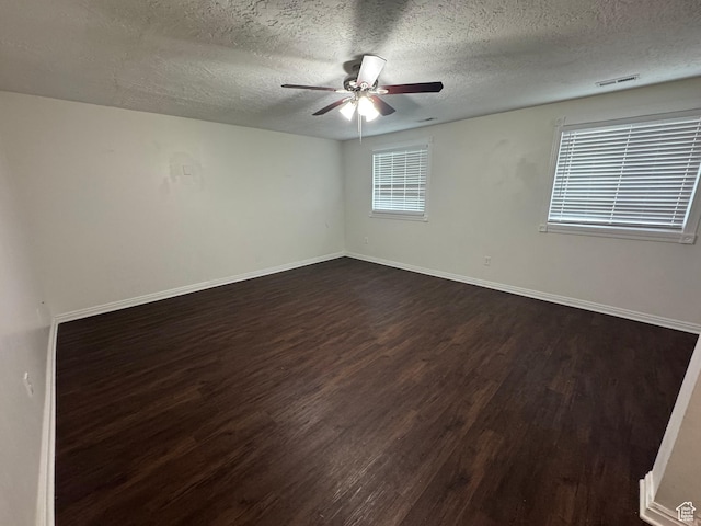 1952 E Sunset Dr, Layton, UT 84040 - spare room with visible vents, a ceiling fan, a textured ceiling, and dark wood-style floors