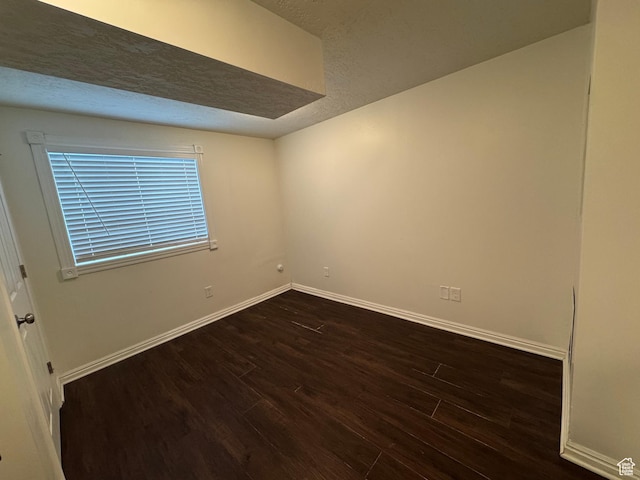 1952 E Sunset Dr, Layton, UT 84040 - unfurnished room with a textured ceiling, baseboards, and dark wood-type flooring