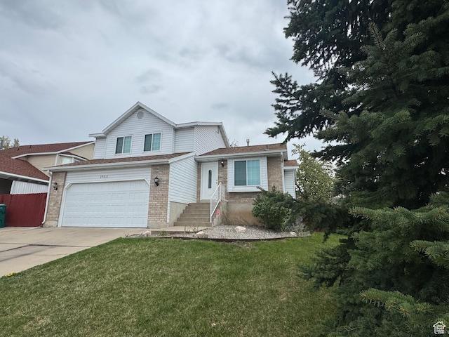 1952 E Sunset Dr, Layton, UT 84040 - view of front of house with an attached garage, concrete driveway, a front lawn, and brick siding