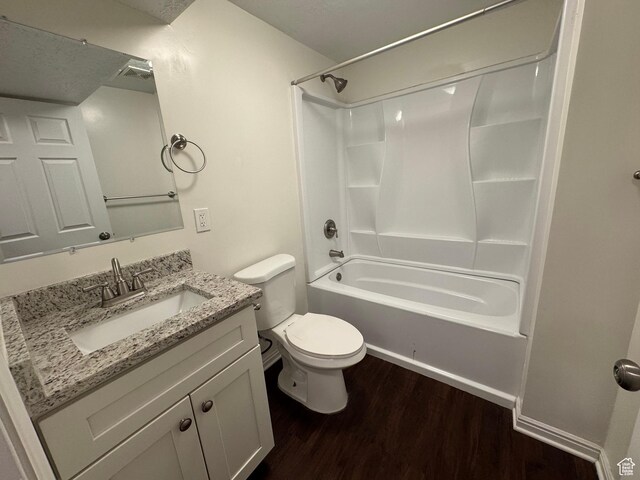 1952 E Sunset Dr, Layton, UT 84040 - full bathroom featuring toilet, shower / washtub combination, wood finished floors, and vanity