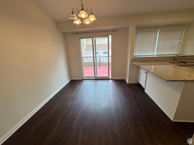 1952 E Sunset Dr, Layton, UT 84040 - unfurnished dining area featuring baseboards, a notable chandelier, dark wood-style floors, and a sink