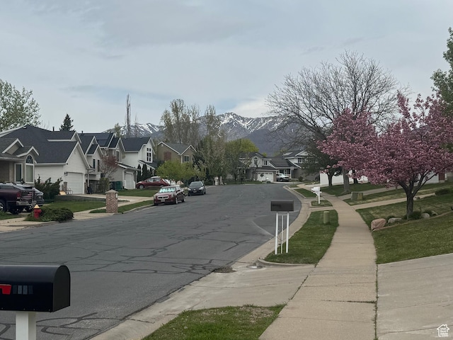 1952 E Sunset Dr, Layton, UT 84040 - view of street with curbs, a mountain view, sidewalks, and a residential view