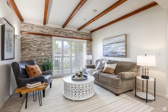 carpeted living room featuring baseboards and beam ceiling