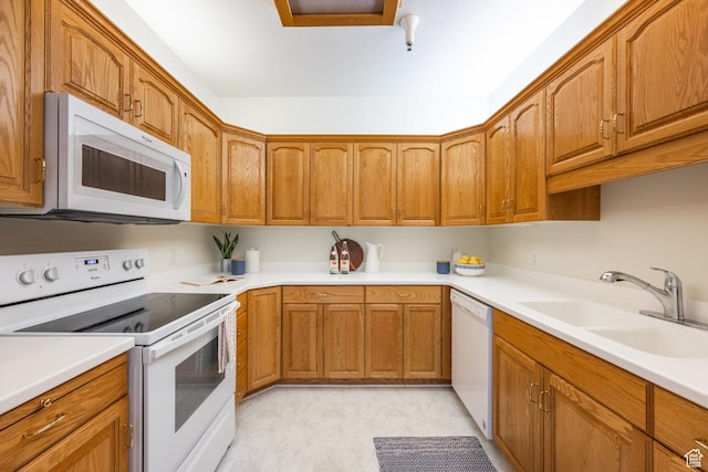 11035 S Grape Vine Cv Unit 106, Sandy, UT 84070 - kitchen with white appliances, brown cabinets, a sink, and light countertops