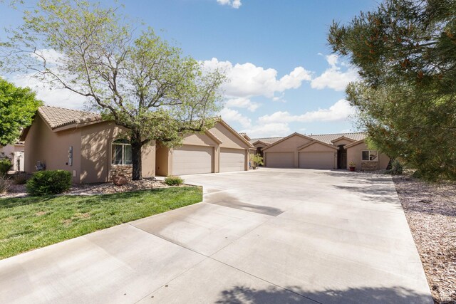 525 N 2480 W, Hurricane, UT 84737 - ranch-style home featuring a tiled roof, a garage, stucco siding, and driveway