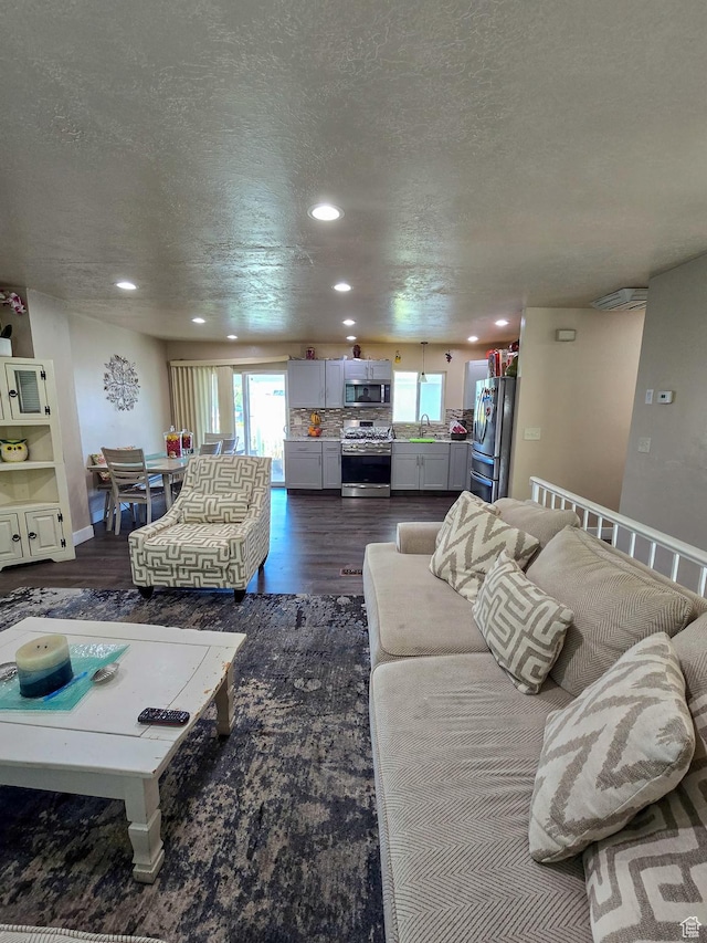 3505 W San Marcos Cir, West Valley City, UT 84119 - living room featuring recessed lighting, dark wood-style floors, and a textured ceiling