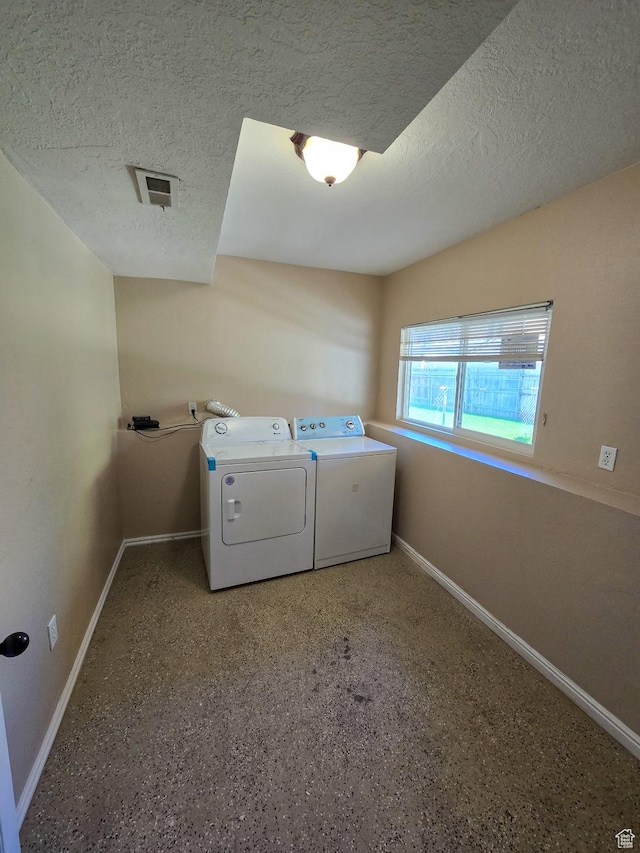 3505 W San Marcos Cir, West Valley City, UT 84119 - laundry room with baseboards, laundry area, a textured ceiling, and washer and clothes dryer