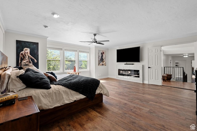 11622 S Worthington Ct E, Sandy, UT 84092 - bedroom with ornamental molding, a textured ceiling, wood finished floors, baseboards, and a glass covered fireplace