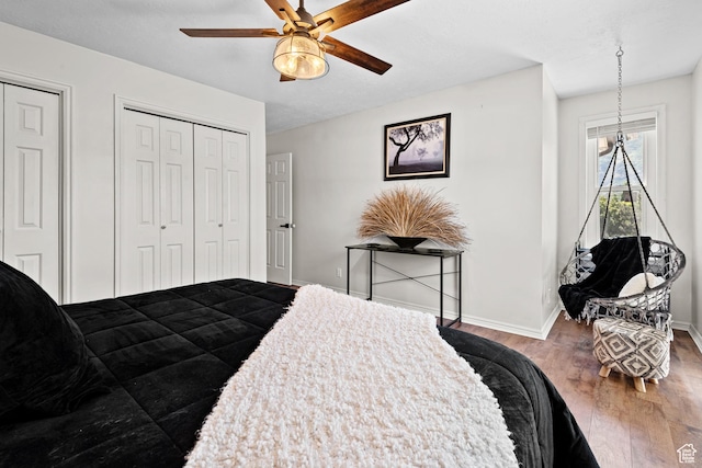 11622 S Worthington Ct E, Sandy, UT 84092 - bedroom with wood finished floors, baseboards, two closets, and a ceiling fan