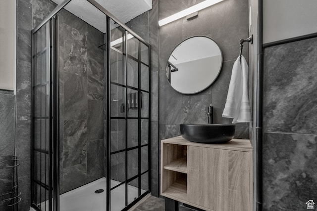 11622 S Worthington Ct E, Sandy, UT 84092 - bathroom featuring tile walls, a shower stall, and vanity