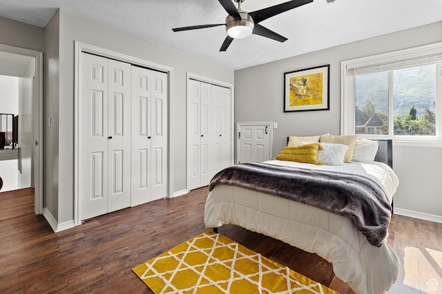 11622 S Worthington Ct E, Sandy, UT 84092 - bedroom with baseboards, two closets, dark wood-style floors, and a ceiling fan