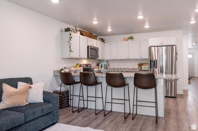 375 N 700 W, Vernal, UT 84078 - kitchen with white cabinets, a peninsula, open floor plan, and appliances with stainless steel finishes