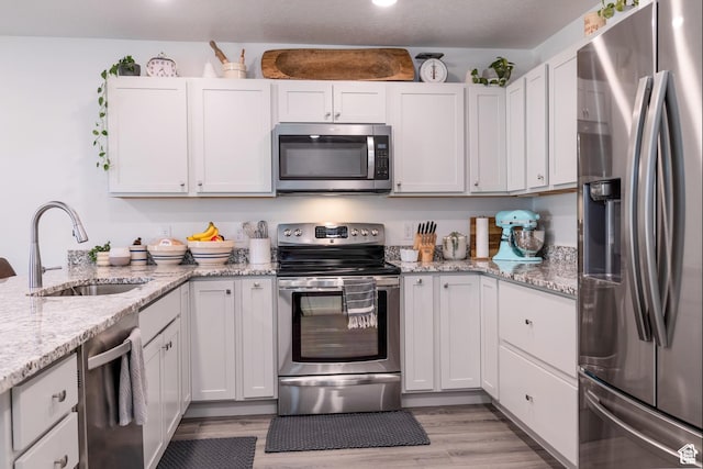 375 N 700 W, Vernal, UT 84078 - kitchen featuring a sink, appliances with stainless steel finishes, light stone countertops, and light wood-type flooring