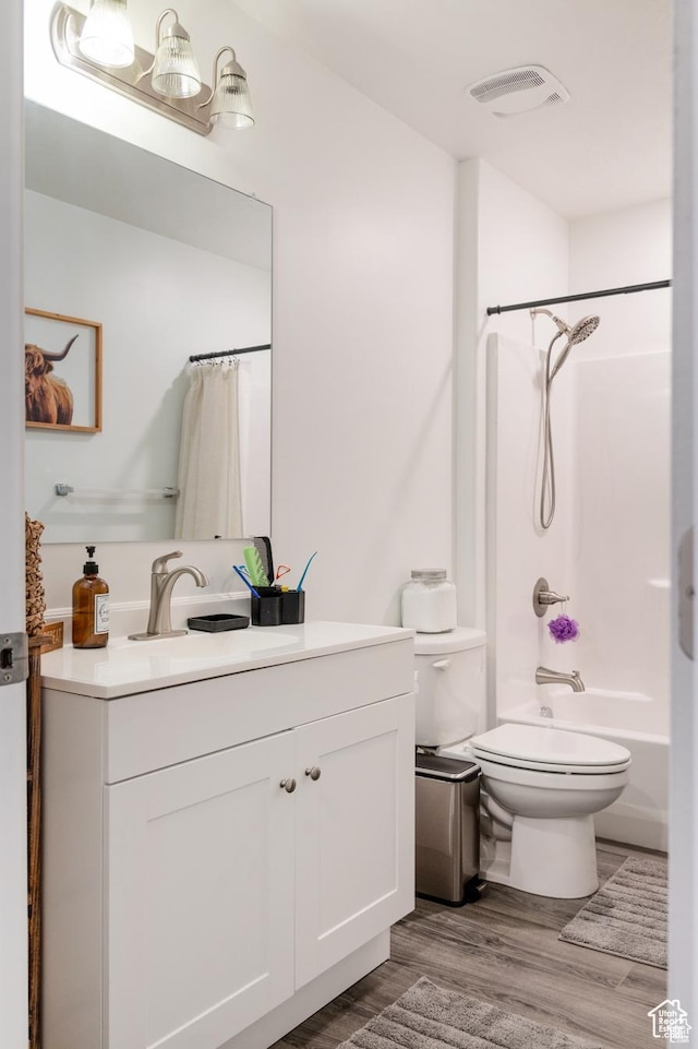 375 N 700 W, Vernal, UT 84078 - bathroom featuring vanity, visible vents, wood finished floors, toilet, and shower / bathtub combination with curtain