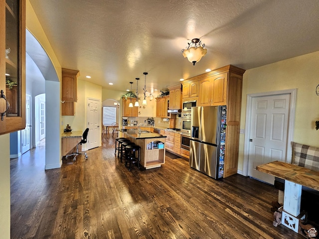 598 W 1620 S, Lehi, UT 84043 - kitchen featuring stainless steel appliances, arched walkways, dark wood-type flooring, a breakfast bar area, and a kitchen island