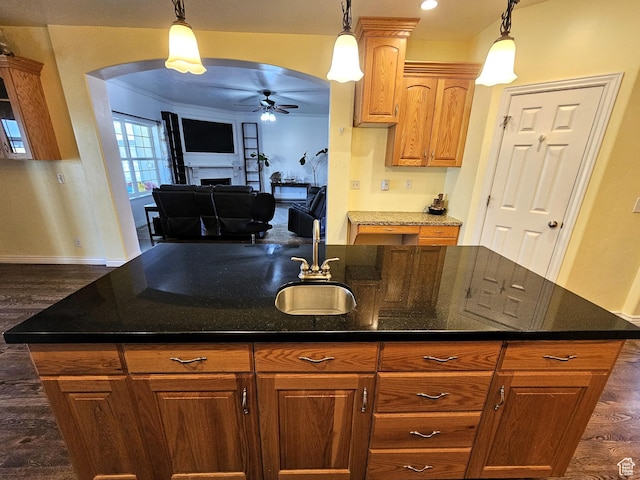 598 W 1620 S, Lehi, UT 84043 - kitchen featuring a ceiling fan, arched walkways, dark wood finished floors, a fireplace, and a sink