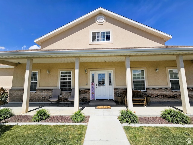 598 W 1620 S, Lehi, UT 84043 - view of exterior entry featuring brick siding, stucco siding, and a porch