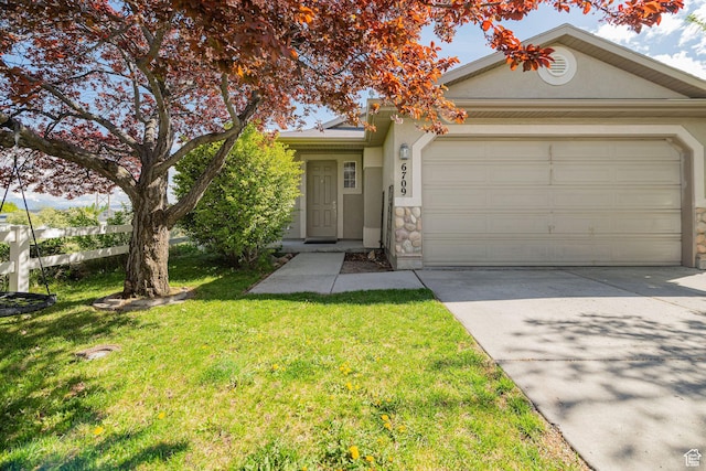 6709 S Empress Ln W, West Jordan, UT 84081 - view of front of home with an attached garage, driveway, a front yard, and stucco siding