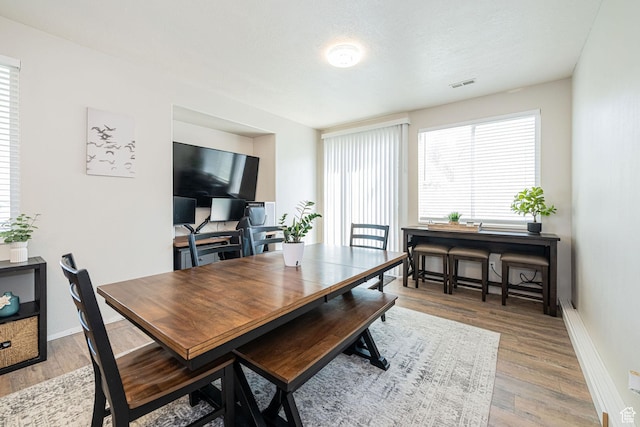 6709 S Empress Ln W, West Jordan, UT 84081 - dining area with baseboards, wood finished floors, and visible vents