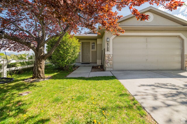 6709 S Empress Ln W, West Jordan, UT 84081 - view of front facade featuring driveway, a front yard, a garage, stone siding, and stucco siding