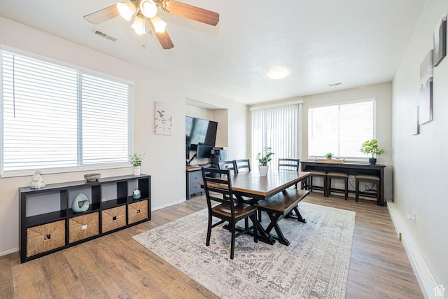 6709 S Empress Ln W, West Jordan, UT 84081 - dining room with visible vents, baseboards, ceiling fan, and wood finished floors
