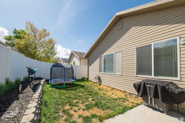 6709 S Empress Ln W, West Jordan, UT 84081 - view of yard with a fenced backyard and a trampoline