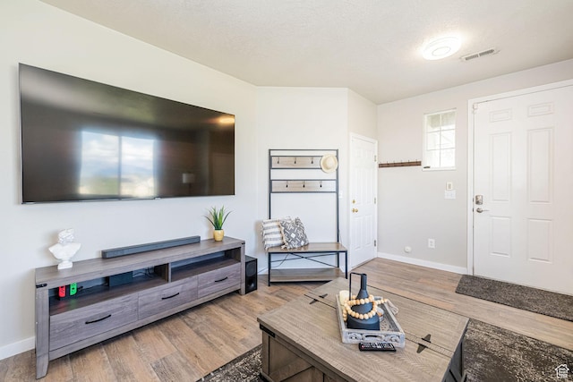 6709 S Empress Ln W, West Jordan, UT 84081 - living room with baseboards, wood finished floors, and visible vents