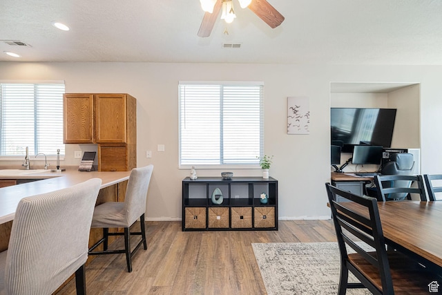 6709 S Empress Ln W, West Jordan, UT 84081 - office area with visible vents, a ceiling fan, a sink, light wood-style flooring, and a wealth of natural light