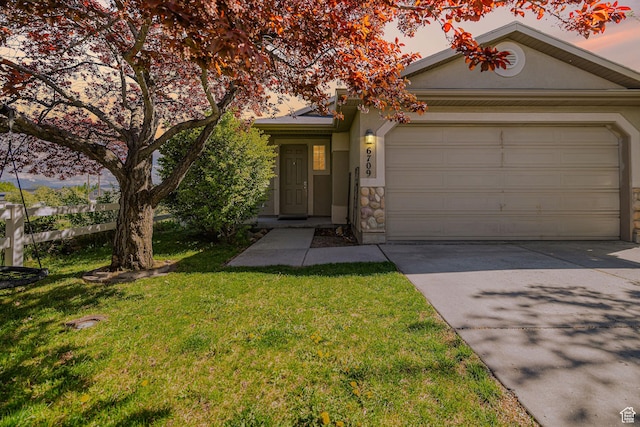 6709 S Empress Ln W, West Jordan, UT 84081 - view of front of property with a yard, concrete driveway, an attached garage, stone siding, and stucco siding