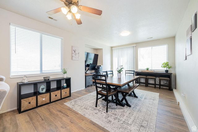 6709 S Empress Ln W, West Jordan, UT 84081 - dining area with visible vents, a ceiling fan, baseboards, and wood finished floors