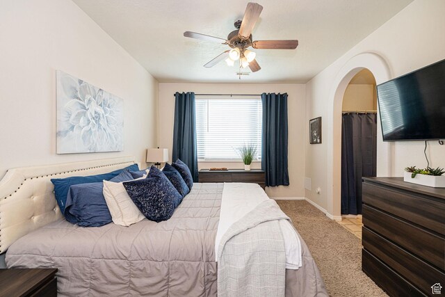 6709 S Empress Ln W, West Jordan, UT 84081 - bedroom with arched walkways, baseboards, a ceiling fan, and carpet flooring
