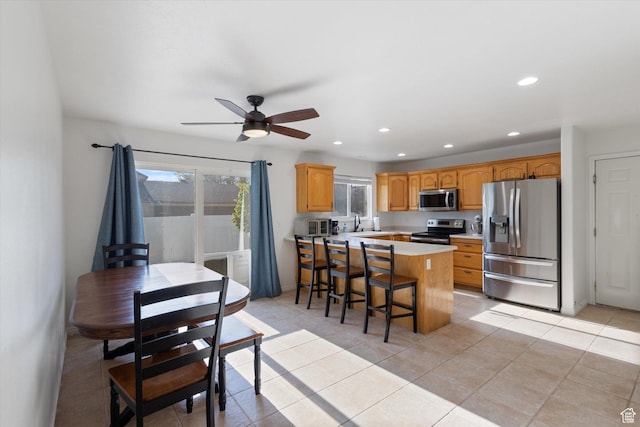 1295 N 190 E, Lehi, UT 84043 - kitchen featuring a kitchen breakfast bar, recessed lighting, light countertops, a ceiling fan, and stainless steel appliances