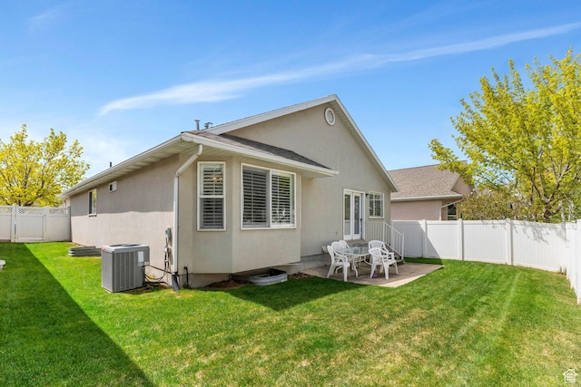 597 E Villager Ln, Midvale, UT 84047 - back of house featuring central AC, a patio, a fenced backyard, stucco siding, and a lawn