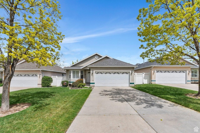 597 E Villager Ln, Midvale, UT 84047 - single story home with fence, a front lawn, concrete driveway, an attached garage, and stucco siding