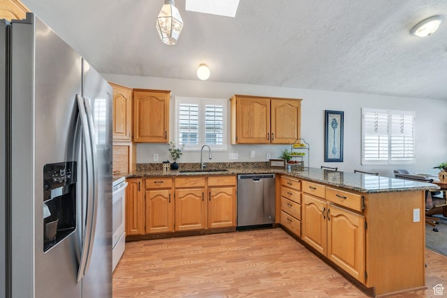 597 E Villager Ln, Midvale, UT 84047 - kitchen with a sink, dark stone countertops, appliances with stainless steel finishes, and a peninsula