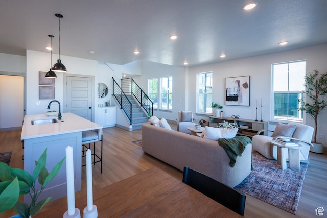 8093 S 615 E, Sandy, UT 84070 - living room featuring a healthy amount of sunlight, recessed lighting, stairs, and light wood-style flooring